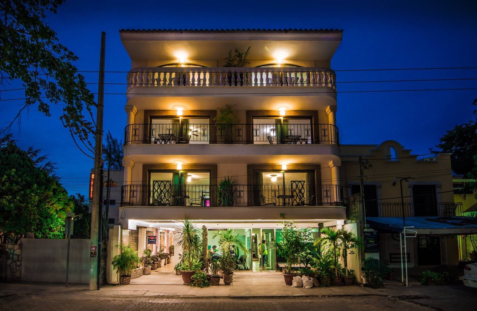 Suites Corazón: building entrance with balconies and plants